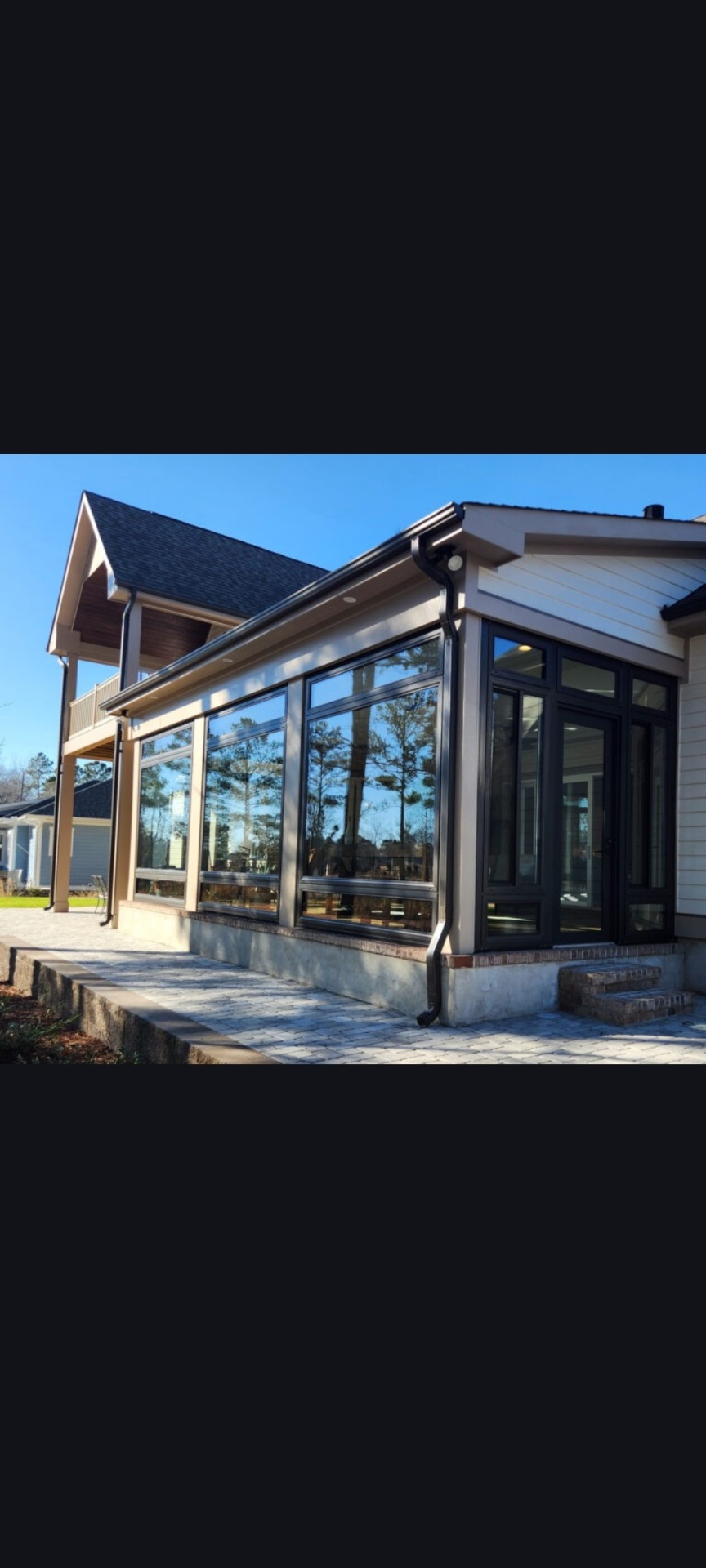 Custom glass sunroom addition on a coastal Carolina home